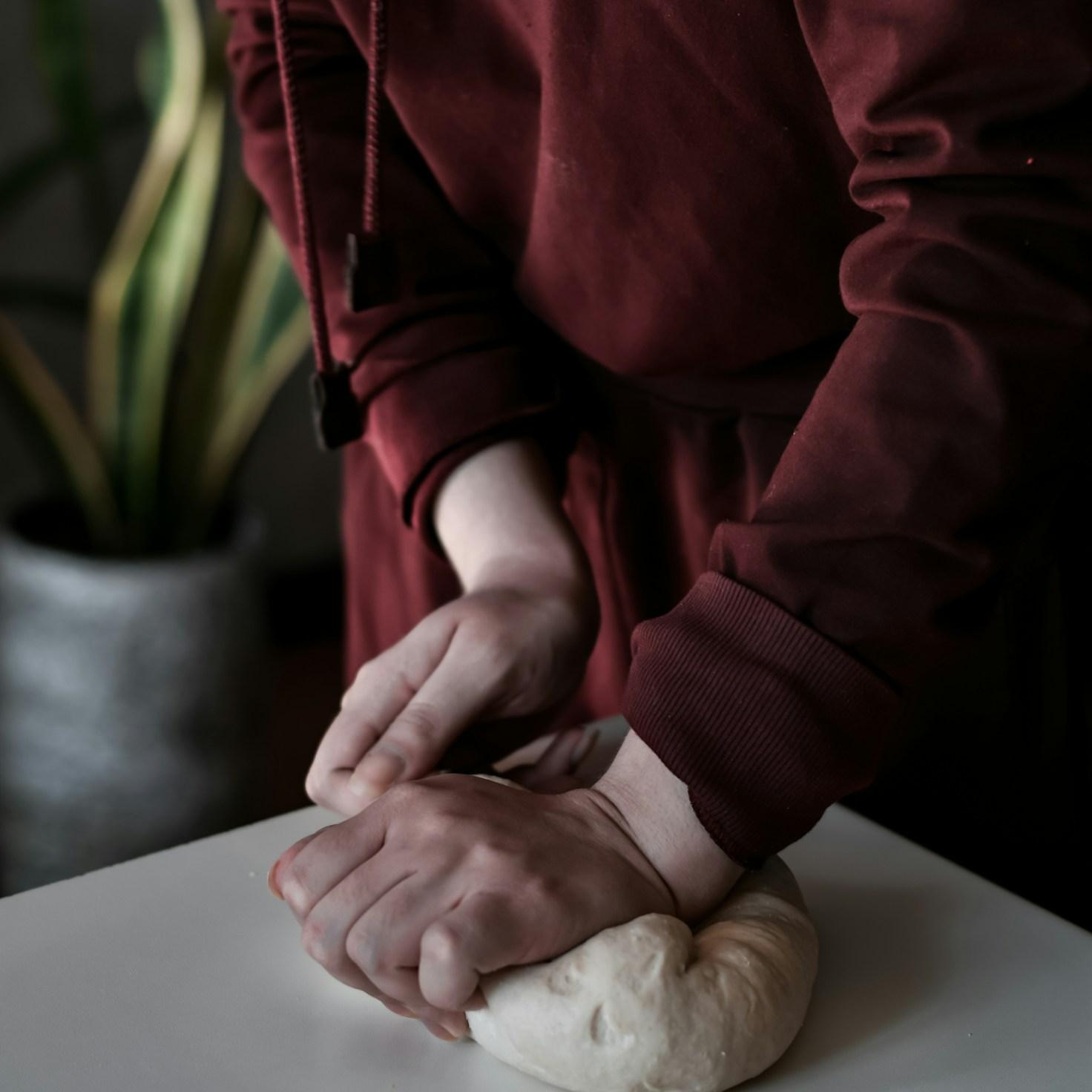 Diverse group of community members sharing a meal together, showcasing the social bonds formed through collaborative cooking